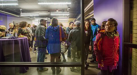 People talk and eat, during the University of Washington's UW-Othello Campus open house in Seattle, Washington, on Jan. 16, 2019. (Photo: Carolyn Bick)