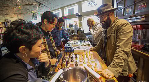 Estelita's Library curator Edwin Lindo, right, plays chess, during the first meeting of the People's Chess Club at Estelita's Library in Seattle, Washington, on Jan. 20, 2019. (Photo: Carolyn Bick)