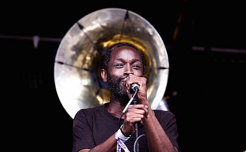 A performer sings and plays the guitar on the main stage, during the Georgetown Carnivale in Seattle, Washington, on June 8, 2019. (Photo: Carolyn Bick)