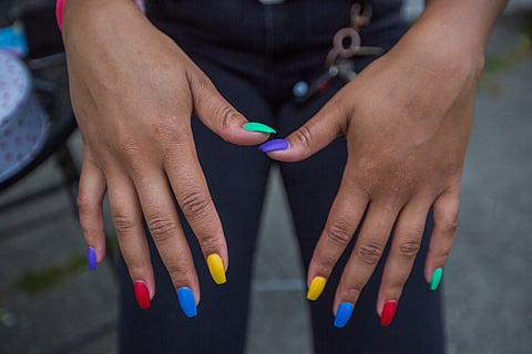 Jadea Brundidge shows off her rainbow nails, during a Pride event hosted by Sway & Swoon DJ Collective at Estelita's Library, in Seattle, Washington, on June 22, 2019.
