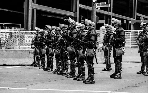 Seattle Police dressed in full riot gear to protect delegates to the WTO Conference and stop property damage.