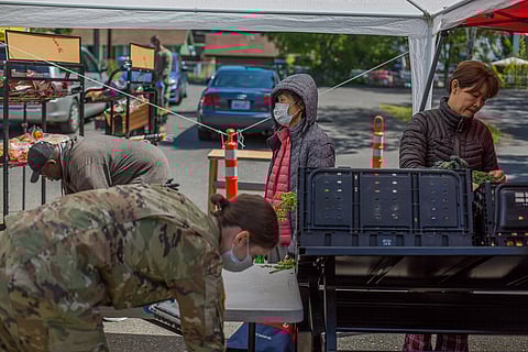 An elder, center, waits for her companion, right, at the White Center Food Bank in Seattle, Washington, on May 7, 2020. (Photo: Carolyn Bick)