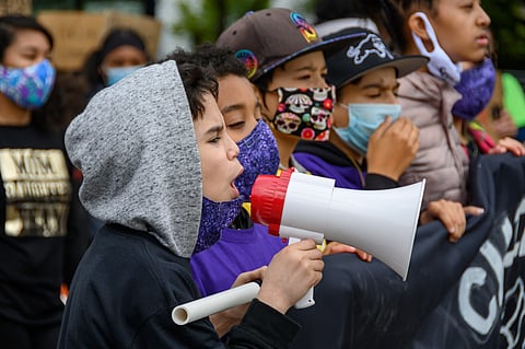 Seattle Children's March youth leader Ori leads a chant on the bullhorn.  (Photo: Sharon H. Chang)