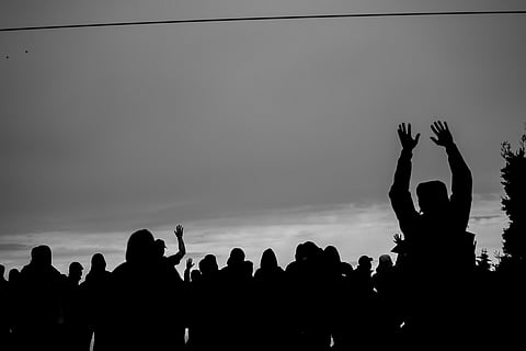 People are silhouetted at Jefferson Park, as they begin to assemble to listen to organizers speak, during the March of Silence down 23rd Ave. South, Seattle, Washington, on June 12, 2020. (Photo: Carolyn Bick)