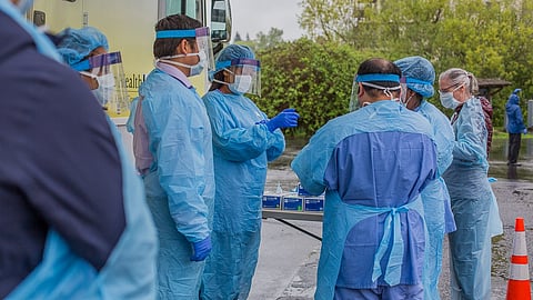 Medical staff prepare to receive a person to be tested for the novel coronavirus at Rainier Beach's Atlantic City Boat Ramp testing site in Seattle, Washington, on April 22, 2020. (Photo: Carolyn Bick)