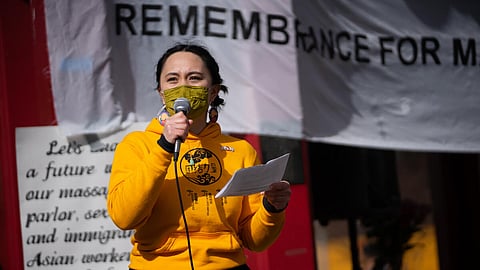 A representative of MPOP (Massage Parlor Outreach Project 女工互助小组) addresses a crowd gathered at Seattle's Hing Hay park. (Photo: Chloe Collyer)