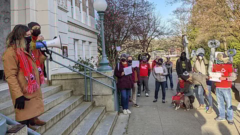 SEA President Jennifer Matter and Seattle Public Schools (SPS) teacher Hannah Graether speak to teachers during a walkout at Franklin High School on Tuesday, March 30, 2021. Teachers for intensive service pathways students did not return to in-class instruction for two and a half days to draw attention to what they say are inadequate safety precautions and disruptions for students with special needs as a result of SPS reopening plans. (Photo: Ari McKenna)