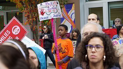 Photo of a young child holding a sign at a 2018 Families for Families rally in Seattle, Washington. (Photo: Susan Fried)