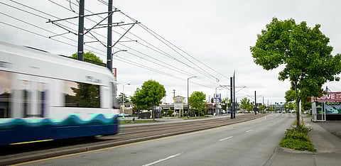 A link light rail shuttle passes by Graham Street and Rainier Avenue. (Photo: Lizz Giordano)