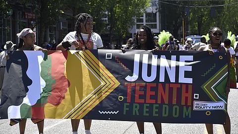 Black youth hold the banner at the start of King County Equity Now's Juneteenth Freedom March. (Photo: Maile Anderson)