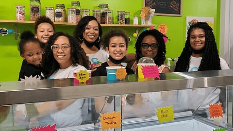 Creamy Cone Cafe officially opened on Memorial Day weekend and is Rainier Beach's only ice cream shop. Owner Ashanti Mayfield (pictured fourth from left) and her sister Alexis Jones (third from left) have enlisted the help of both their families to make their dream ice cream shop a reality. (Photo: Jennie Nichols)