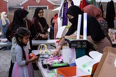 A vendor shows various bracelets to a prospective customer. (Photo: Ronnie Estoque)