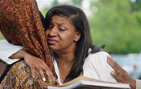 Lorenzo Anderson's mother Donnitta Sinclair gets hug from a cousin during the celebration of Lorenzo's life, July 2 at Jimi Hendrix Park. (Photo: Susan Fried)