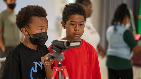 Students Terry Hill, 11, (left) and Ezekiel Rapier, 11, (right) position the camera while filming a movie they helped write during the 5 day Reel Youth Film Camp August 16- 20 at the Rainier Arts Center. (photo: Susan Fried)