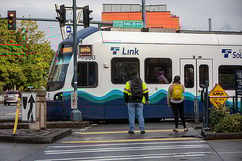 Riders wait to cross Martin Luther King Jr. Way South near the Columbia City Link light rail station. (Photo: Lizz Giordano)