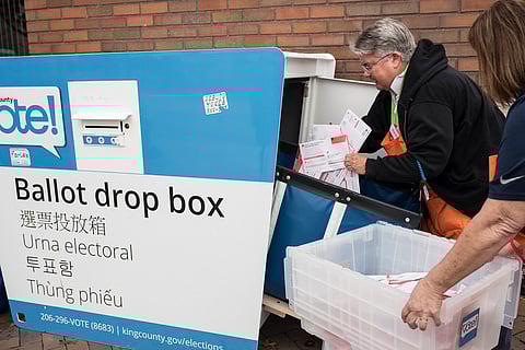 Election workers collect ballots. (Photo courtesy of King County Elections.)