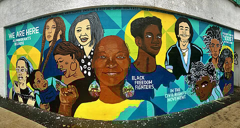 Mural titled "We Are Here" by VivaLaFreedpdx, Alex Chiu, A'Misa Chiu, Justin Phillip, Kiana Chelew, Layna Lewis, and Ameya Marie Okamoto. Photo attributed to Chris Christian (under a Creative Commons, CC BY-NC 2.0 license).