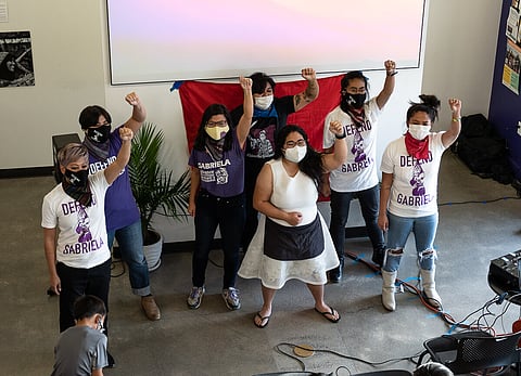 Members of GABRIELA Seattle raise their fists in the air after their cultural performance. (Photo: Ronnie Estoque)