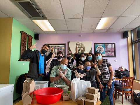"The Eggrolls" taking a group photo after serving 150 meals to community. (Photo: Elliot Crane)