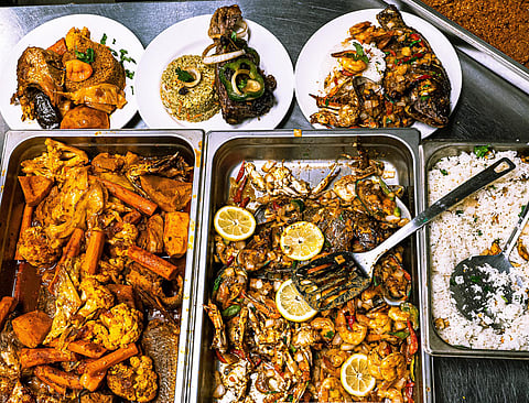 Jollof rice, seafood "C'est Bon," and grilled lamb prepared by sisters Adama Jammah and Oumie Sallah. (Photo: Dylan Cate)