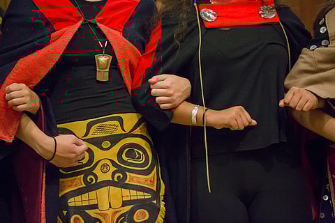 Haida Heritage group members link arms in solidarity, during the fifth annual celebration of Indigenous People's Day at Daybreak Star Indian Cultural Center in Seattle, Washington, on Oct. 8, 2018. (Photo: Carolyn Bick}