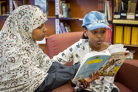 A student at Martin Luther King Jr. Elementary School in Seattle reads aloud to her Team Read coach in 2019. Photo by Lisa Bontje.