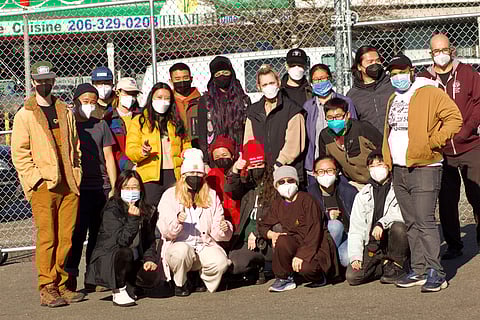 Chef Tanya (front row, fourth from left) and her volunteer team of "Eggrolls" provide free meals, clothes, and community for houseless neighbors at ChuMinh Tofu Deli in Little Saigon. (Photo: Henry Jensen)