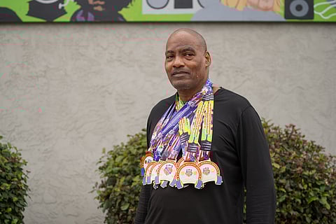 Mark Bryant stands outside the Southeast Seattle Senior Center with his many weightlifting medals. (Photo: Susan Fried)