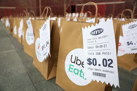 Local gig workers delivered 400 to-go bags outside Seattle City Hall on Feb. 16, 2022, to draw attention to the wages they currently receive from app companies, including Uber, DoorDash, and Instacart. (Photo: Alex Garland)