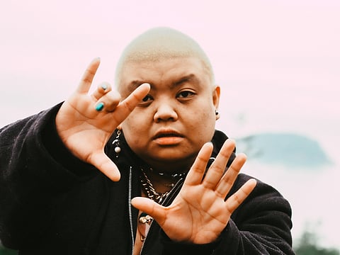 Nic Masangkay posing with their hands in front of the camera.