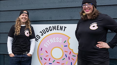 Founder of No Judgment Fitness and trainer Sophia Walker (left) stands next to her wife, Bernadette Wright (right). (Photo: Chloe Collyer)