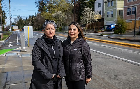 A new yellow concrete divider running down the middle of Delridge Way blocks left-turn access to the Refugee Immigrant Family Center Bilingual Preschool (RIFC). To some, the barrier might not seem like a big deal, but Luz Casio (left), director of RIFC, and Karina Rojas, director of SouthWest Early Learning (SWEL), say it is a big deal for their community. (Photo: Lizz Giordano)