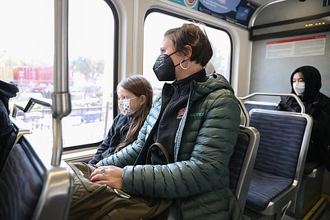 Bailey Hancock (left) and Julie Holstad ride the Sound Transit light rail south from SoDo Station on Tuesday, just hours after Puget Sound transit agencies lifted COVID-19 mandatory mask requirements. (Photo: Alex Garland)