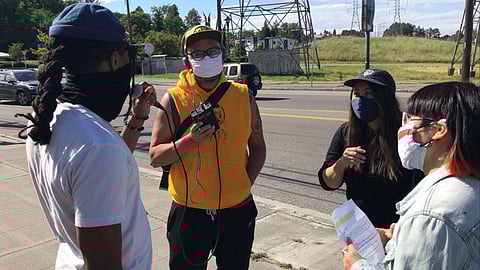 Members of "WKUS?" interviewing Jerrell Davis from Rainier Beach Action Coalition (RBAC) about their thoughts on community safety. (Photo: Yin Yu)