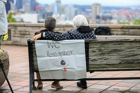 Two people pause during a press conference/protest at Kerry Park on Tuesday, May 3, 2022. (Photo: Alex Garland)