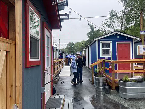 Visitors tour the Southend Tiny House Village, 9109 Martin Luther King Jr. Way South, near the Rainier Beach light rail station. (Photo: Phil Manzano)