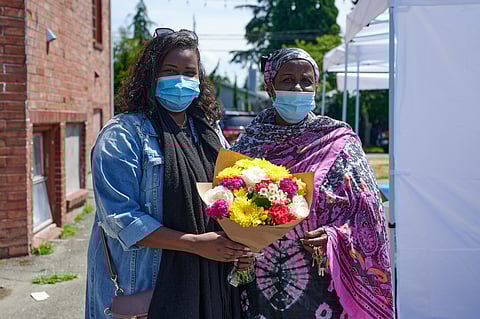 Associate Director Bilan Aden (left) and Executive Director Hamdi Abdulle (right) of African Community Housing and Development (ACHD) at the Delridge Farmers Market last year. (Photo: Maximilian Golub)