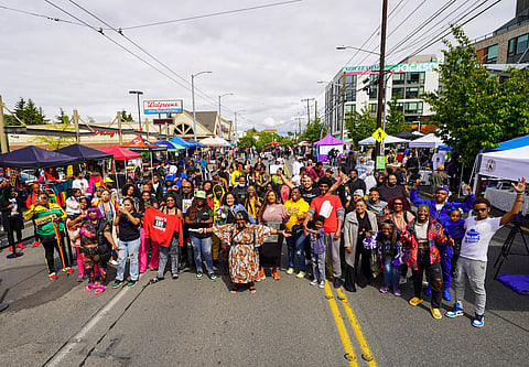Hundreds of business owners and community members gathered in front of the stage on 23rd and Jackson to take a group photo. (Photo: Susan Fried)