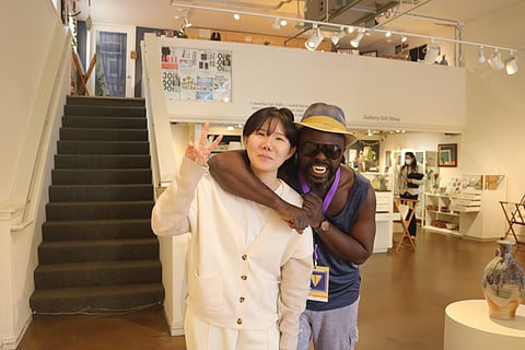 Hee Kim (left) and Osa Elaiho (right). Elaiho, an artist and manager at Columbia City Gallery, said he knows all the artists at the gallery and the story of each work. "Once you know the history and background, you will have a better understanding of the work," Elaiho said at Columbia City Gallery. (Photo: Hazel Choi)