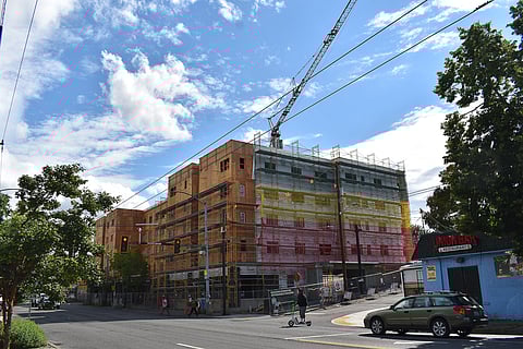 Cranes are no longer an uncommon sight along Rainier Avenue South, such as this one towering over the future Ethiopian Village, a 100-unit affordable senior housing project. A few blocks north, two cranes are positioned over Flourish on Rainier, a 182-unit affordable workforce housing project, as an estimated 11,030 units are expected to come online by 2025. (Photo: Phil Manzano)