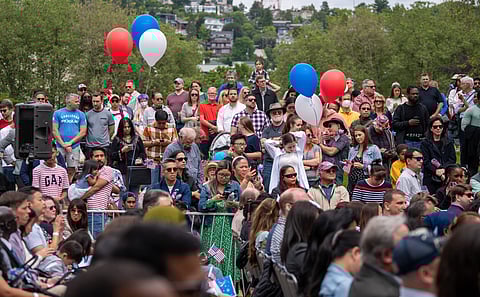 The families and friends of the candidates for U.S. citizenship watch the ceremony as their relatives are sworn in during the 37th Annual Naturalization Ceremony at Seattle Center on July 4. (Photo: Susan Fried)