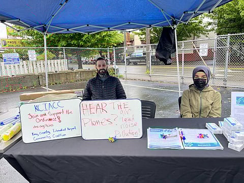 Christian Poulsen and a student table and inform community members at the Duwamish Community Hub. (Photo: Velma Veloria, former Washington State Representative, 11th District)