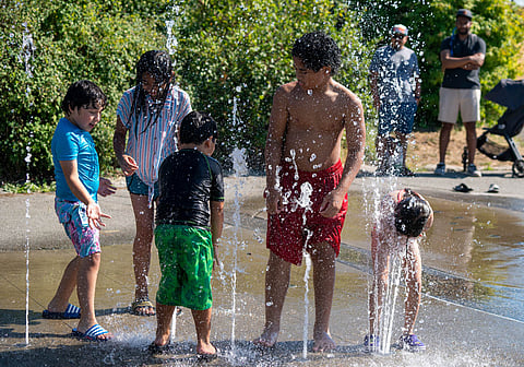 A group of kids take advantage of the cool water at Beacon Mountain Spray Park at Beacon Hill's Jefferson Park on Saturday, July 30, 2022. (Photo: Susan Fried)