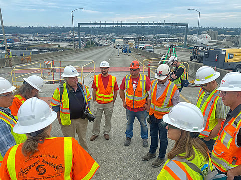 Construction crew gathers on the West Seattle Bridge. (Photo: Tim Durkan, courtesy of SDOT Photos under a Creative Commons, CC BY-NC 2.0 license).