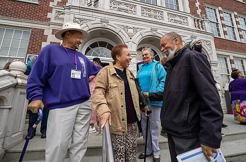 Graduates from 1968 greet each other on the stairs outside the school's front entrance during Garfield's Centennial Celebration. (Photo: Susan Fried)