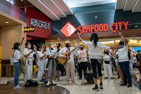 Local Filipino American activists organized a flash mob choir, singing Filipino songs outside the Seafood City entrance inside Westfield Southcenter mall. (Photo: Ronnie Estoque)