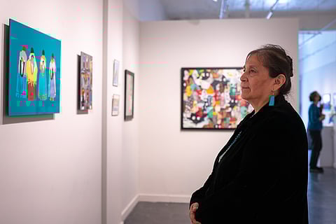 Denise Emerson views her work on display at Gallery 110 in Pioneer Square. (Photo: Felipe Contreras)