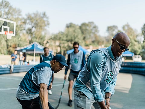 Skyway community members play street hockey with King County Councilmember Girmay Zahilay and King County Executive Dow Constantine. (Photo: Nikki Barron)
