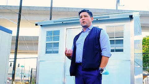 King County Department of Community and Human Services Director Leo Flor with one of the Pallet shelters that would have been part of a shelter expansion in the SoDo neighborhood. (Photo: Erica C. Barnett, courtesy of PubliCola.)