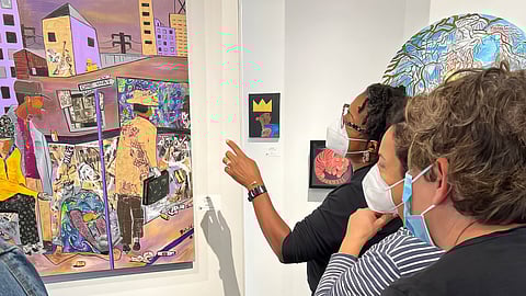 Patrons examine artwork during Gallery Onyx grand opening celebration at Midtown Square. (Photo courtesy of Ashby Reed)